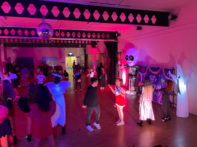 Picture of children dancing at a Halloween Disco.
